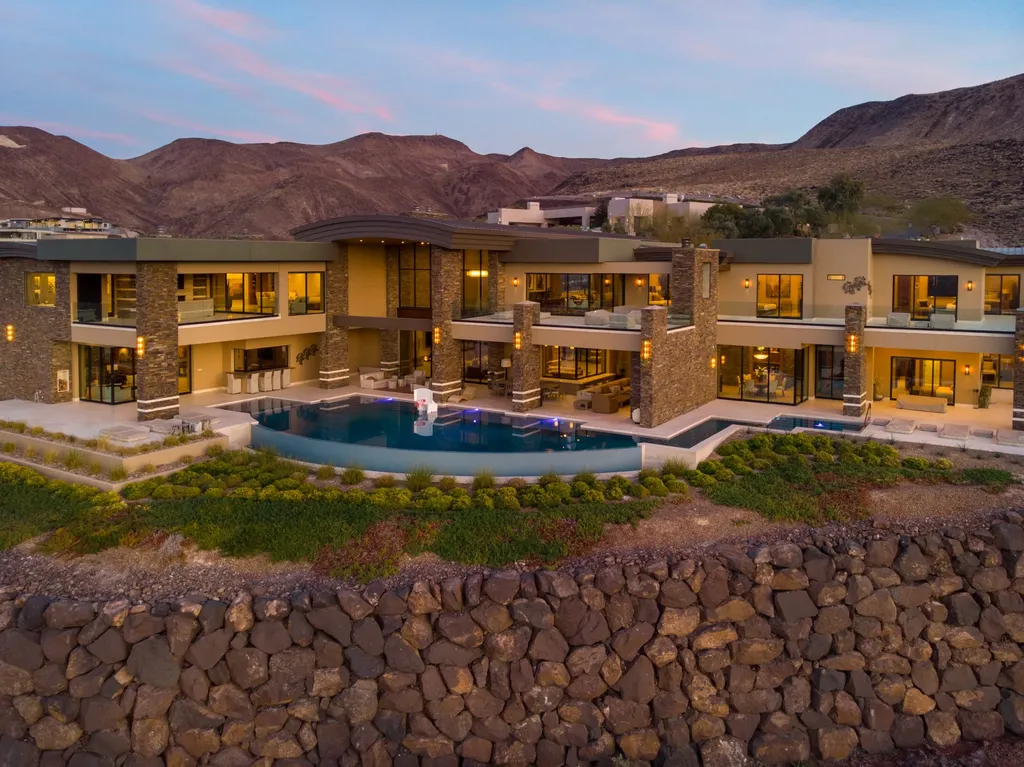 This extraordinary estate located at 761 Dragon Ridge Drive in Henderson, NV offers an unparalleled level of luxury and sophistication. Situated within the exclusive 9-lot enclave in Macdonald Highlands, this magnificent residence is nestled on a sprawling 1.23-acre lot, providing ample space and privacy.