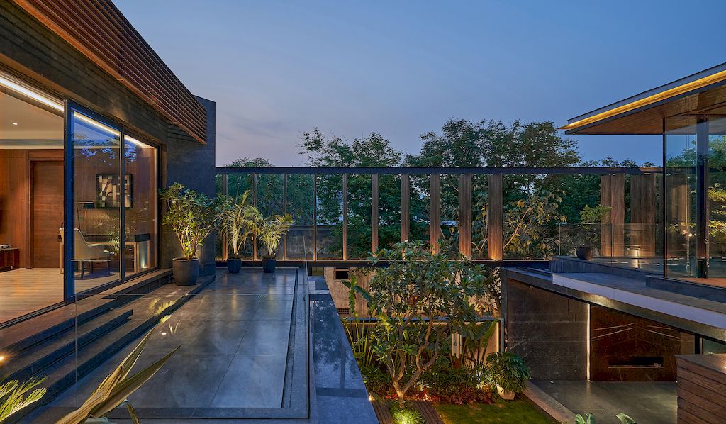 Corner House Connected to Well-landscaped Outdoors by DADA Partners