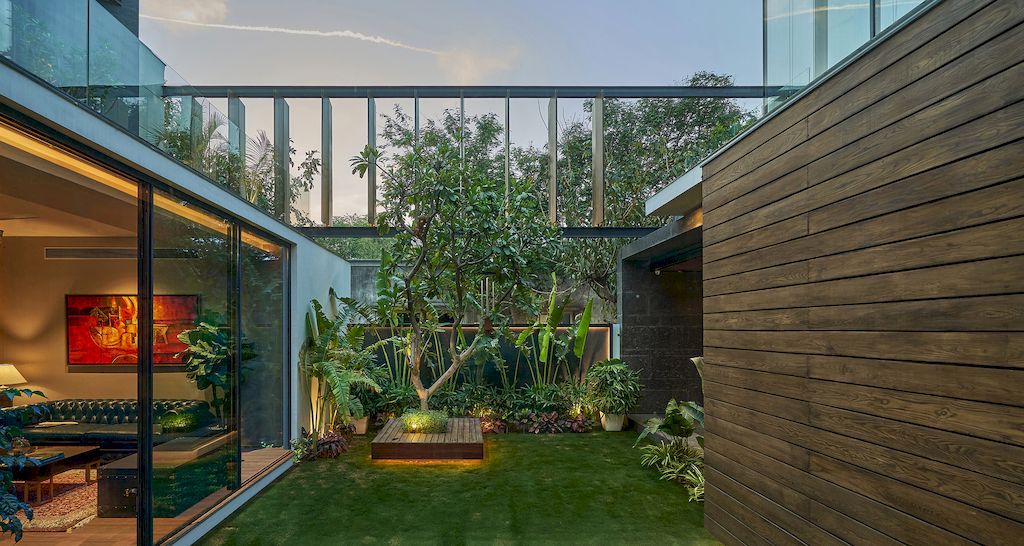 Corner House Connected to Well-landscaped Outdoors by DADA Partners