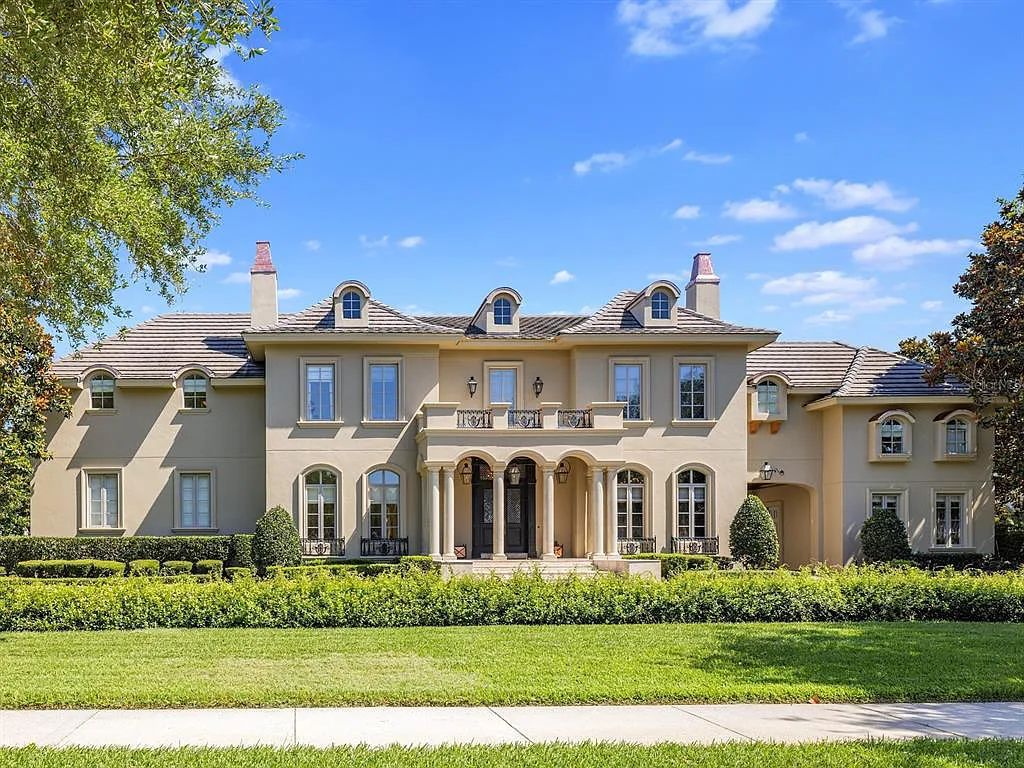 Experience a magnificent New Orleans-inspired custom estate in guard-gated Lake Butler Sound at 11114 Bridge House Road, Windermere, Florida. This 5-bed, 7-bath French Chateau on 0.94 acres boasts a 7,138 sq ft living space, impeccable grounds, and stunning features such as de Gournay hand-painted wallpaper, a gourmet kitchen, and a vaulted pecky cypress ceiling.