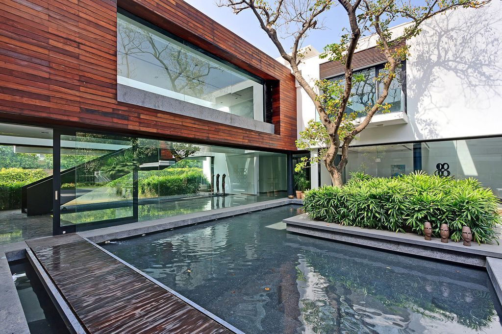 Three Trees House Preserve Trees while Enjoy Natural by DADA Partners