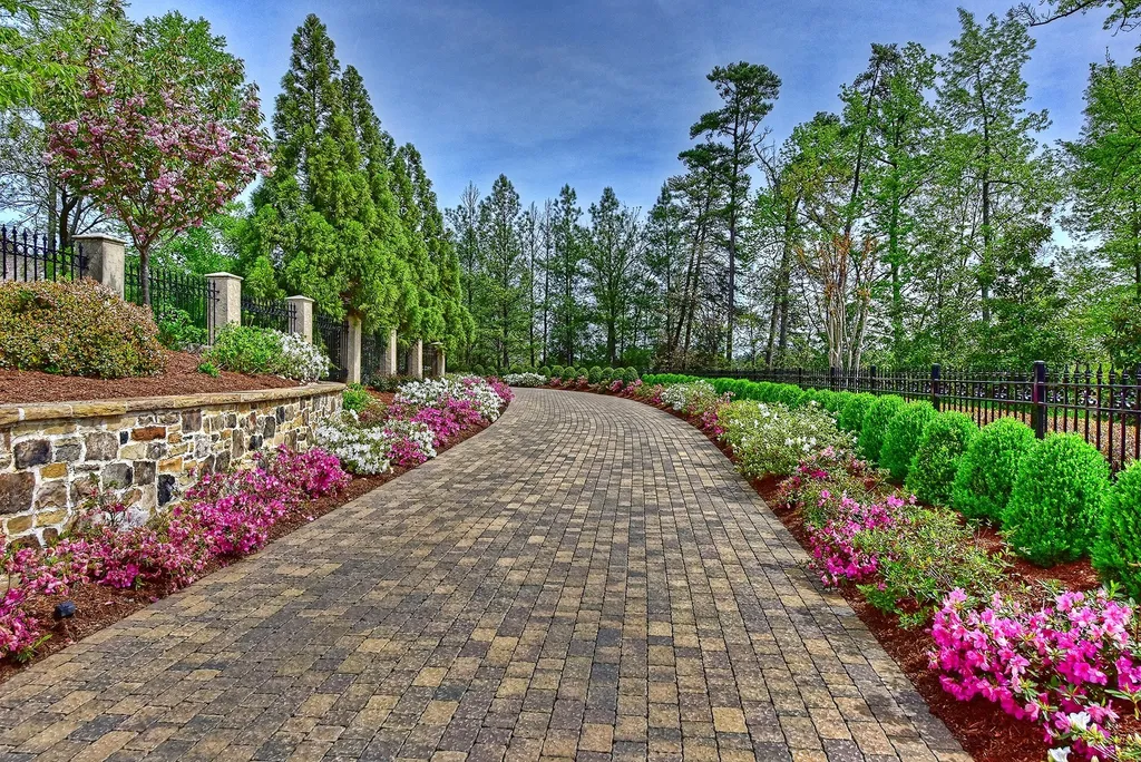 Indulge in the allure and character of the New England coast with this extraordinary Lake Norman estate. As you enter through the private gated drive, you'll be greeted by lush landscaping, creating a gardener's paradise. The estate offers wide open, long-range panoramic views that will take your breath away.