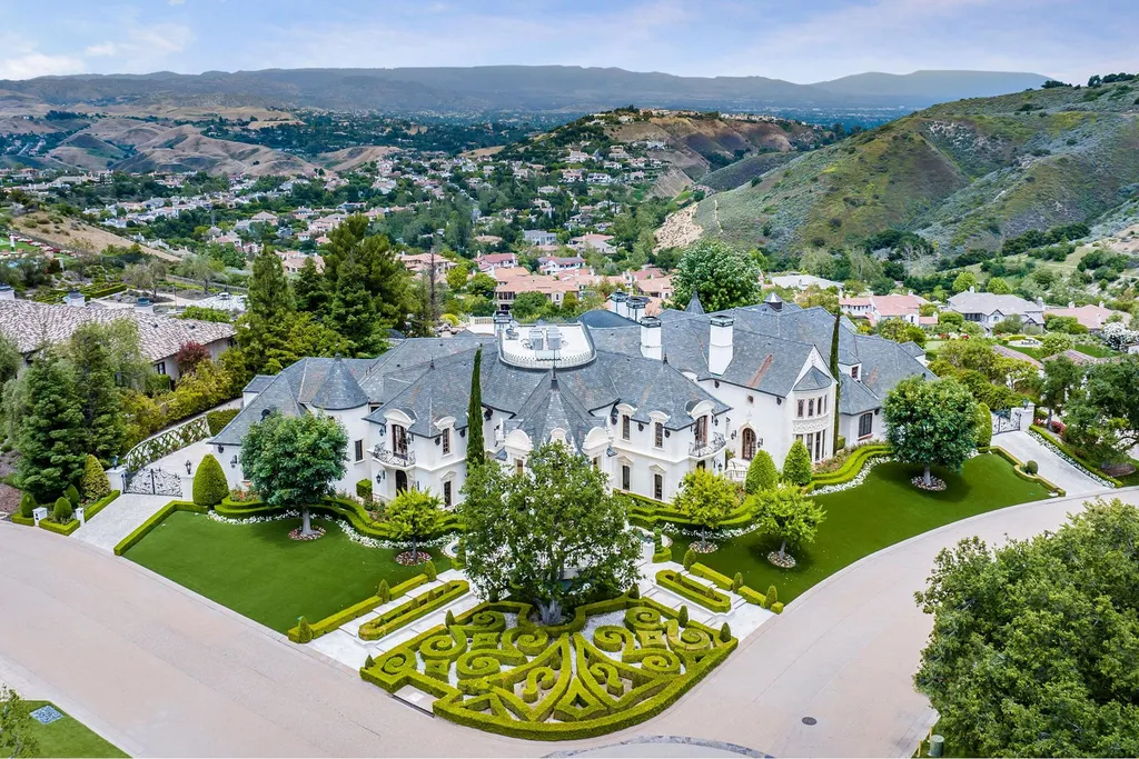 25365 Prado De La Felicidad Home in Calabasas, California. Calabasas, California - Prepare to be captivated by one of the most stunning properties in all of Calabasas. This extraordinary architectural masterpiece showcases French influence and design, nestled behind the prestigious second gate in The Estates at The Oaks. Situated on over 1.1 acres of land and boasting panoramic city and mountain views, this residence is a true testament to luxury and craftsmanship.