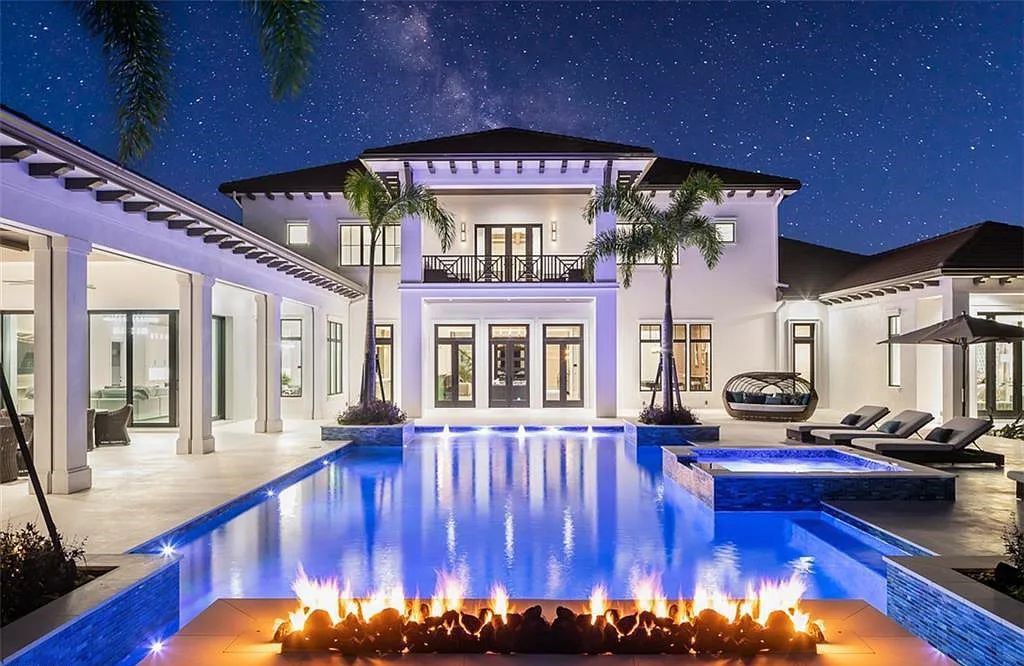 Welcome to 149 Cajeput Drive, Naples, Florida - a newly constructed masterpiece of timeless elegance. This exceptional estate boasts 5 bedrooms, 8 bathrooms, and spans 9,833 square feet.