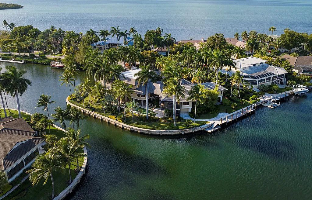 Welcome to 36 W Snapper Point Drive, a stunning waterfront estate in Key Largo, Florida. This 10,930 square feet home, nestled in the exclusive Snapper Point neighborhood, offers panoramic water views from every angle.