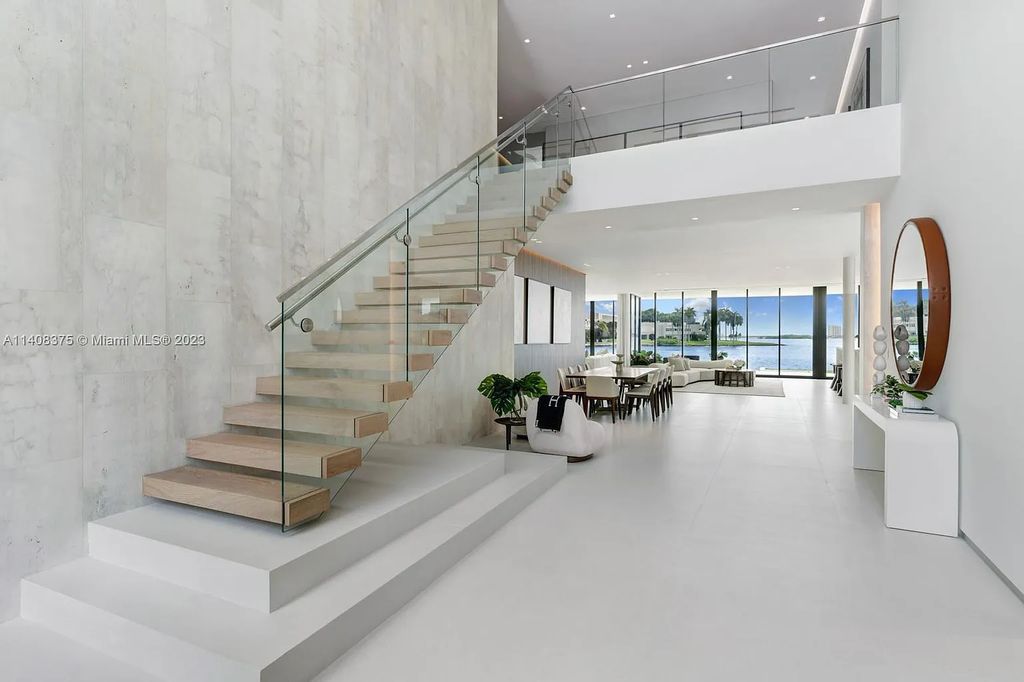 Experience luxury living at its finest in this brand-new custom residence located at 9520 W Broadview Drive, Bay Harbor Islands, Florida. With 8 bedrooms, 10 bathrooms, and over 8,200 square feet of meticulously designed living space, this modern home offers breathtaking open bay views and a seamless indoor-outdoor flow.