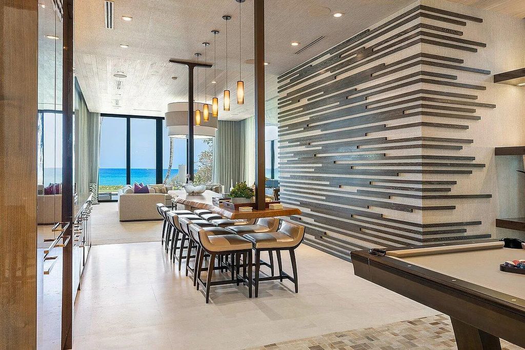 Welcome to 1115 Hillsboro Mile, a luxurious 6-bedrooms, 8-bathrooms home in Hillsboro Beach, Florida. Built in 2017 by Mark Timothy Luxury Homes and Affiniti Architects, this property offers stunning ocean views and a private boat dock.