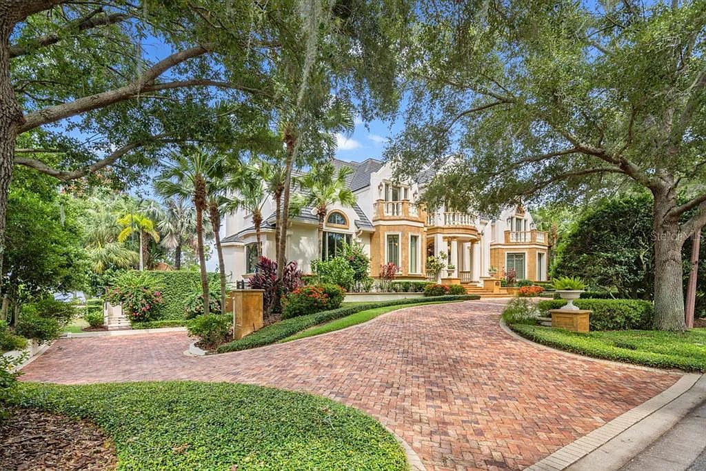 Experience luxury living at 6432 Deacon Circle in Windermere, Florida. This magnificent lakefront estate in the Isleworth Country Club Community offers impeccable craftsmanship, panoramic views, and 11,021 square feet of living space.