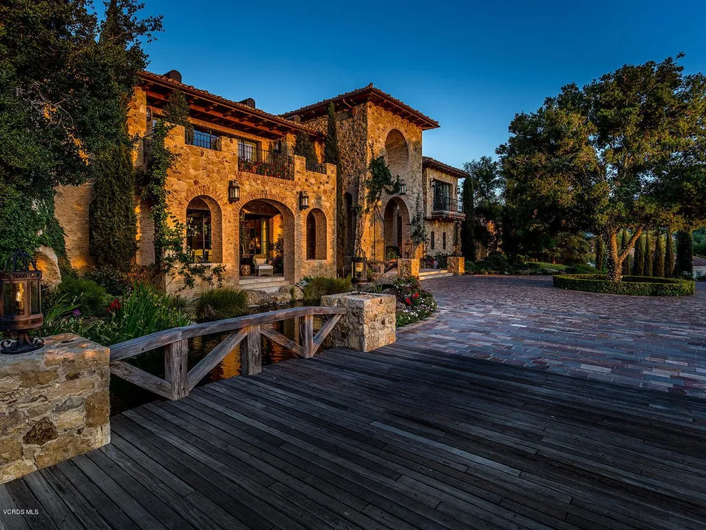 100 West Potrero Road Home in Thousand Oaks, California. Welcome to Villa del Lago, a truly exceptional Tuscan-inspired estate overlooking the picturesque Lake Sherwood. This self-sustainable modern old-world villa spans approximately 24,000 square feet, showcasing unparalleled quality and craftsmanship on a sprawling 4-acre property equipped with its own well, solar power, and generator.