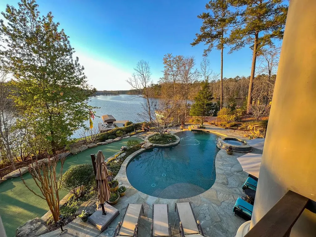 2260 Sandy Ford Home in Greensboro, Georgia. Discover the epitome of elegance and sophistication in this extraordinary lakefront home boasting over 11,000 sq ft of pure luxury. Enjoy stunning lake views, impeccable craftsmanship, and an array of high-end features. 
