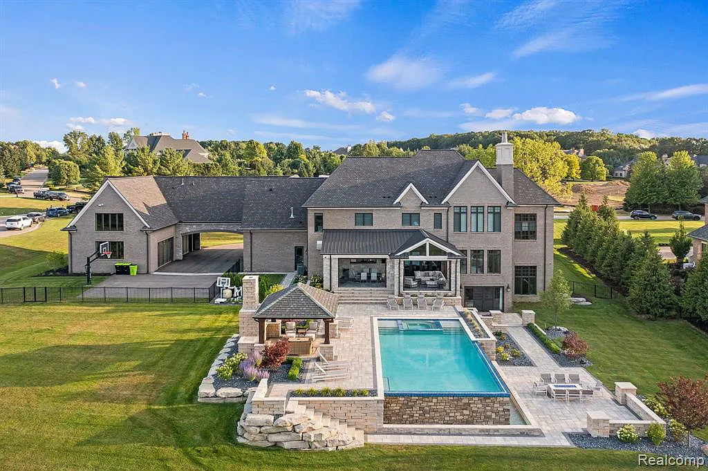 5105 Orchard Ridge Drive Home in Rochester, Michigan. Discover the epitome of luxury living in the prestigious gated community of Orchard Ridge. This custom-built masterpiece spans over 10,000 square feet, boasting impeccable craftsmanship, exquisite finishes, and a private 2-acre oasis.