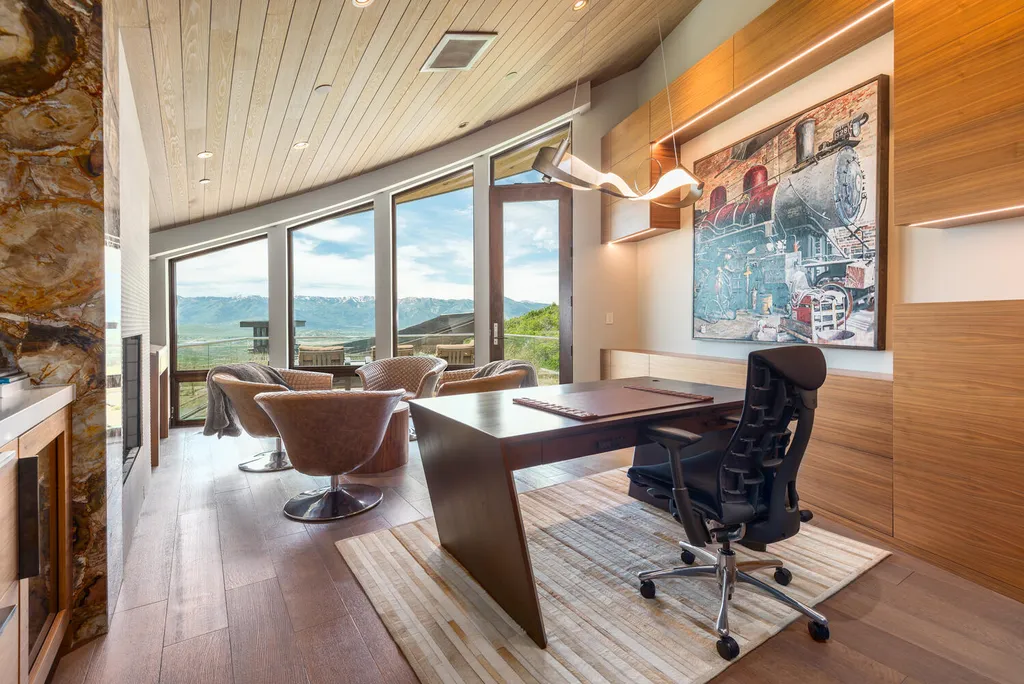 8742 N Lookout Lane Home in Park City, Utah. Experience the pinnacle of modern living in this exceptional six-bedroom, nine-bathroom home designed by Michael Upwall and built by MCC in the prestigious Promontory community. Stunning vistas, a sculptural spiral staircase, high-end fixtures, and luxurious amenities create a harmonious blend of contemporary elegance and comfort. Enjoy the spacious kitchen, private primary suite, home theater, walk-in wine cellar, and much more. This is a rare opportunity to own a true masterpiece of modern design in Utah's breathtaking landscape.