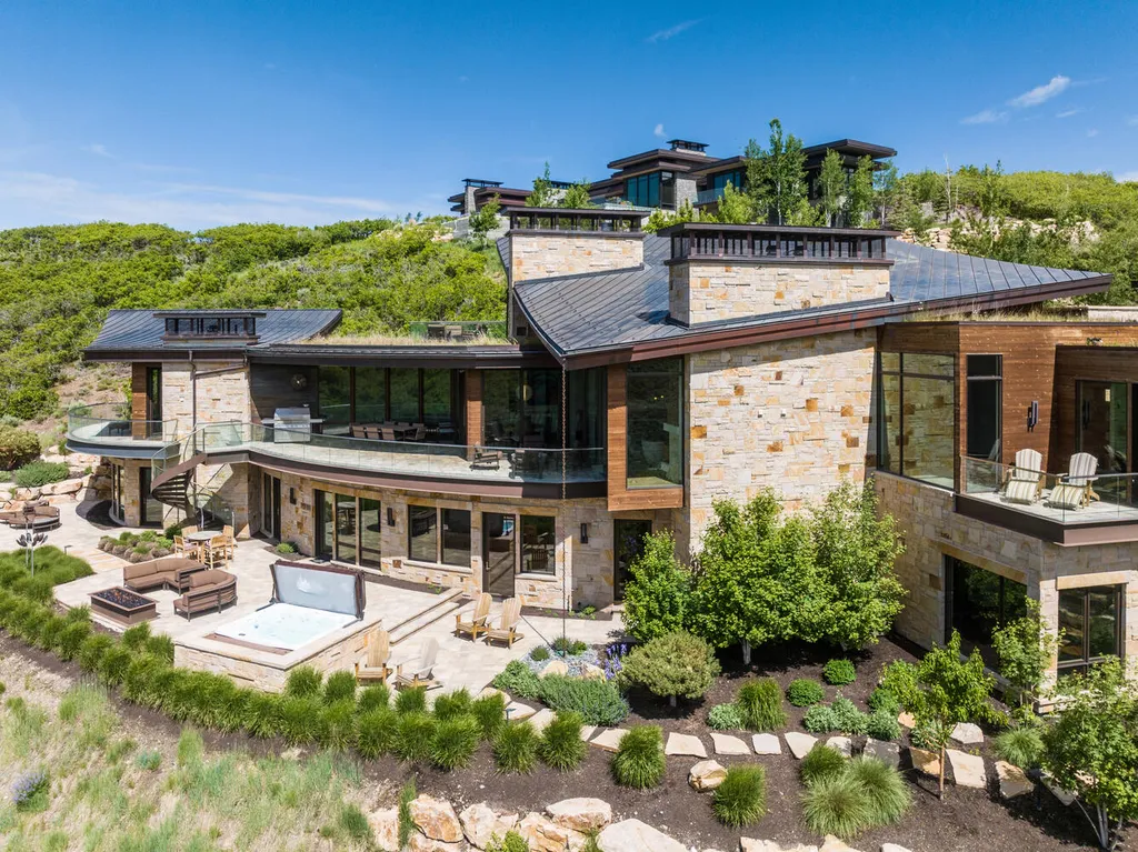 8742 N Lookout Lane Home in Park City, Utah. Experience the pinnacle of modern living in this exceptional six-bedroom, nine-bathroom home designed by Michael Upwall and built by MCC in the prestigious Promontory community. Stunning vistas, a sculptural spiral staircase, high-end fixtures, and luxurious amenities create a harmonious blend of contemporary elegance and comfort. Enjoy the spacious kitchen, private primary suite, home theater, walk-in wine cellar, and much more. This is a rare opportunity to own a true masterpiece of modern design in Utah's breathtaking landscape.