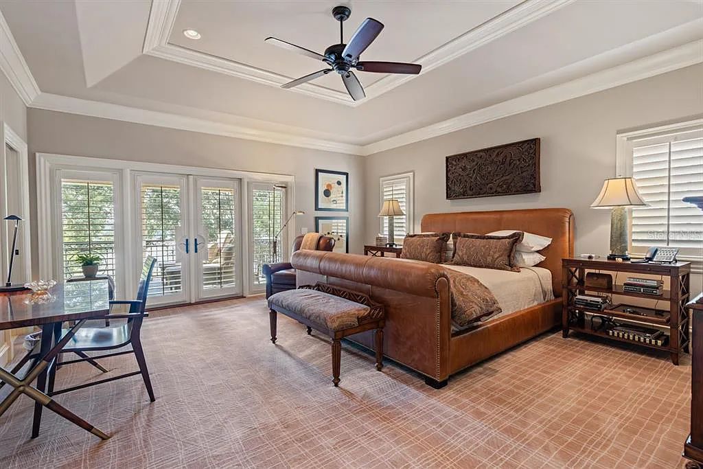 Discover elegance and luxury at 5200 Isleworth Country Club Drive in Windermere, Florida. This magnificent 5-bed, 8-bath estate with 9,482 sq ft of living space is situated on the eighth fairway of the Isleworth Golf and Country Club golf course, offering breathtaking views of Lake Bessie