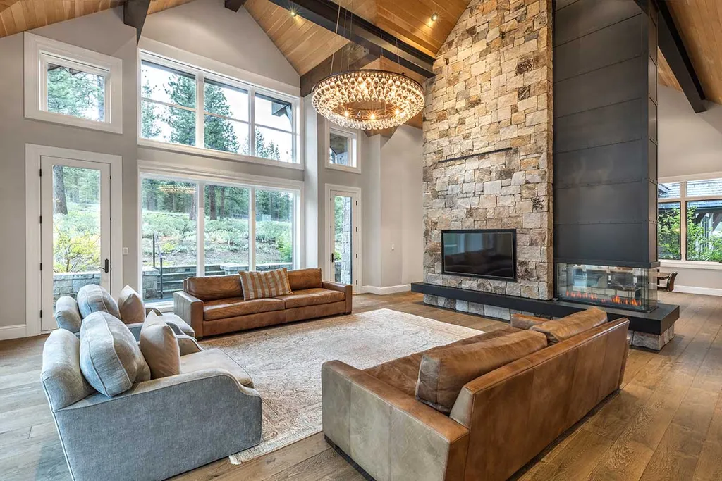 9661 Dunsmuir Way Home in Truckee, California. Prepare to be captivated as you step through the front door of this extraordinary 7,546-square-foot modern mountain home in Martis Camp. The first glimpse is nothing short of awe-inspiring—a vast expanse of glass that serves as both a wall and a stunning 288-bottle wine cellar. This artistic flair extends throughout the 6-bedroom, 7-bathroom residence, creating a truly unique and rewarding living experience.