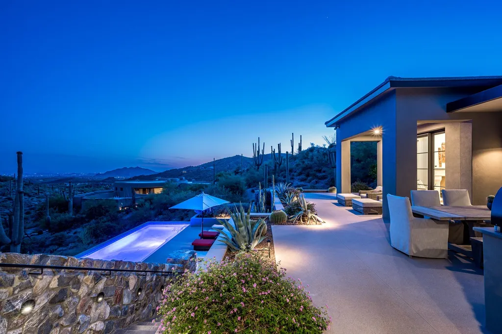 9886 E Sterling Ridge Road Home in Scottsdale, Arizona. Discover the epitome of luxury desert living in this stunning contemporary estate perched on 2.2 acres in the exclusive community of Desert Mountain in North Scottsdale, Arizona. With breathtaking views of the McDowell Mountains, Pinnacle Peak, city lights, and emerald green golf courses, this private oasis offers a serene and tranquil setting. 
