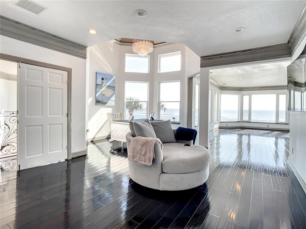 Welcome to 4031 S Atlantic Avenue in Port Orange, Florida - an exquisite beachfront property boasting breathtaking ocean views and a fully renovated design. This gated home offers over 5,300 square feet of living space, featuring 6 bedrooms, 5.5 bathrooms, and an attached in-law suite.