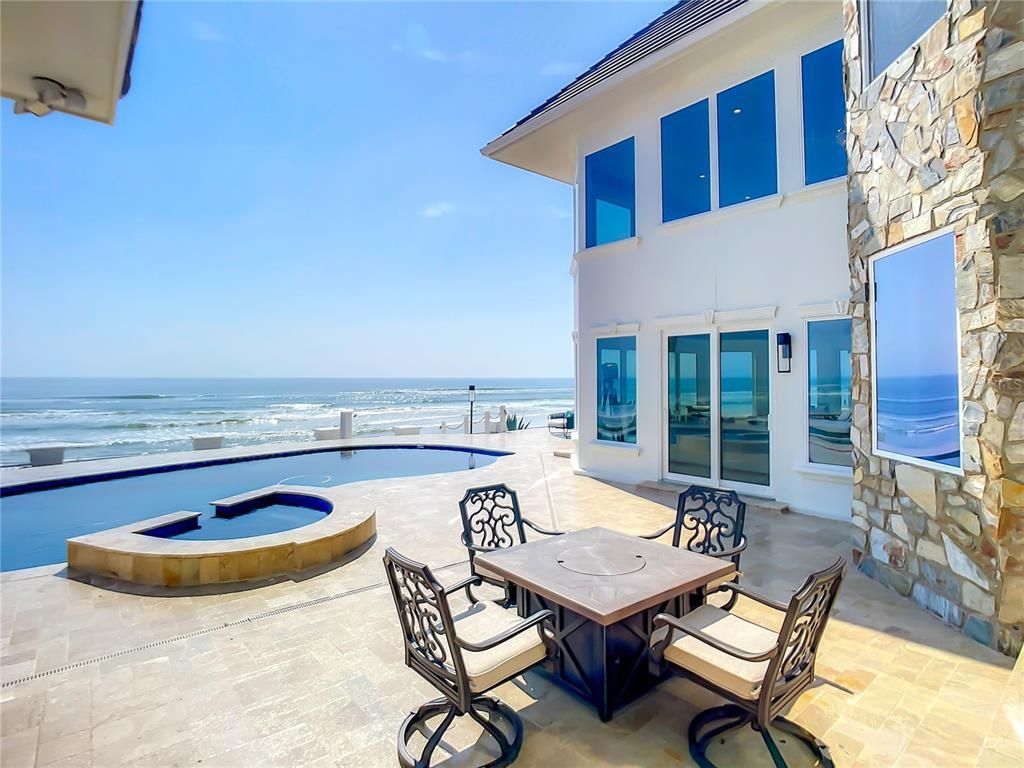 Welcome to 4031 S Atlantic Avenue in Port Orange, Florida - an exquisite beachfront property boasting breathtaking ocean views and a fully renovated design. This gated home offers over 5,300 square feet of living space, featuring 6 bedrooms, 5.5 bathrooms, and an attached in-law suite.