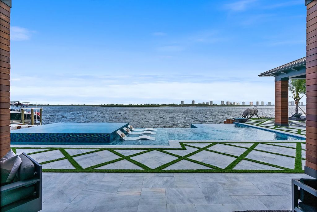 Introducing 1020 Fairview Lane, the crown jewel of Singer Island in Riviera Beach, Florida. This extraordinary waterfront property in Palm Beach Isles offers stunning waterway views, 200 feet of frontage, and direct access to the Palm Beach Inlet.