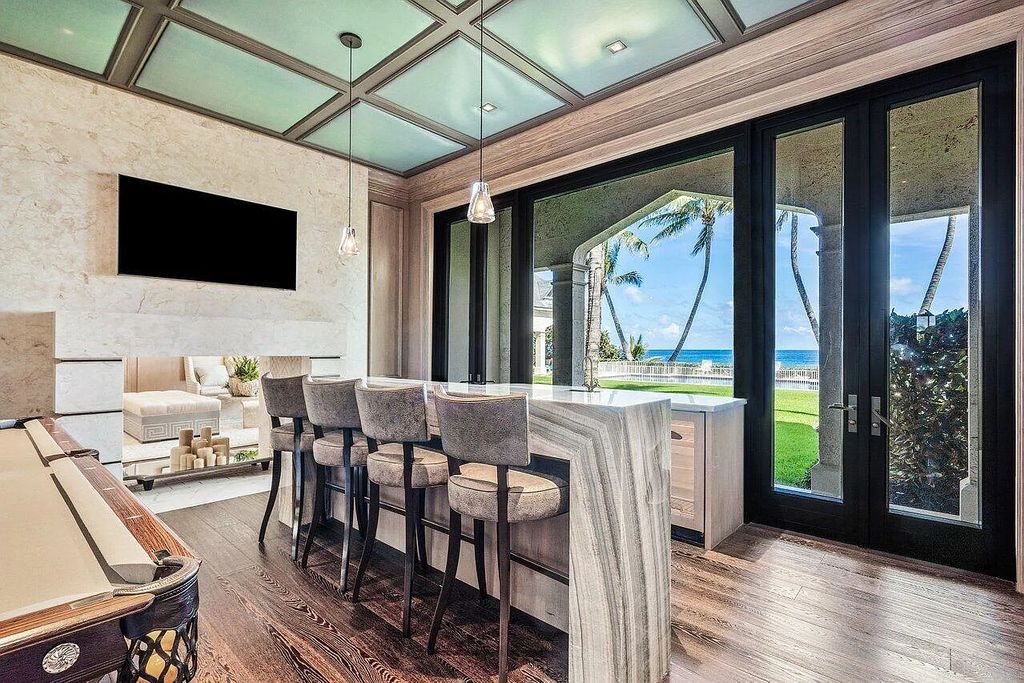 Welcome to 2455 S Ocean Boulevard, Highland Beach, Florida – a masterpiece of modern French-Eclectic architecture on the largest oceanfront lot in the area. This prestigious estate, designed by Madey Architects and constructed by Mark Timothy Luxury Homes, offers 6 bedrooms, 11 bathrooms, and 13,996 square feet of living space.