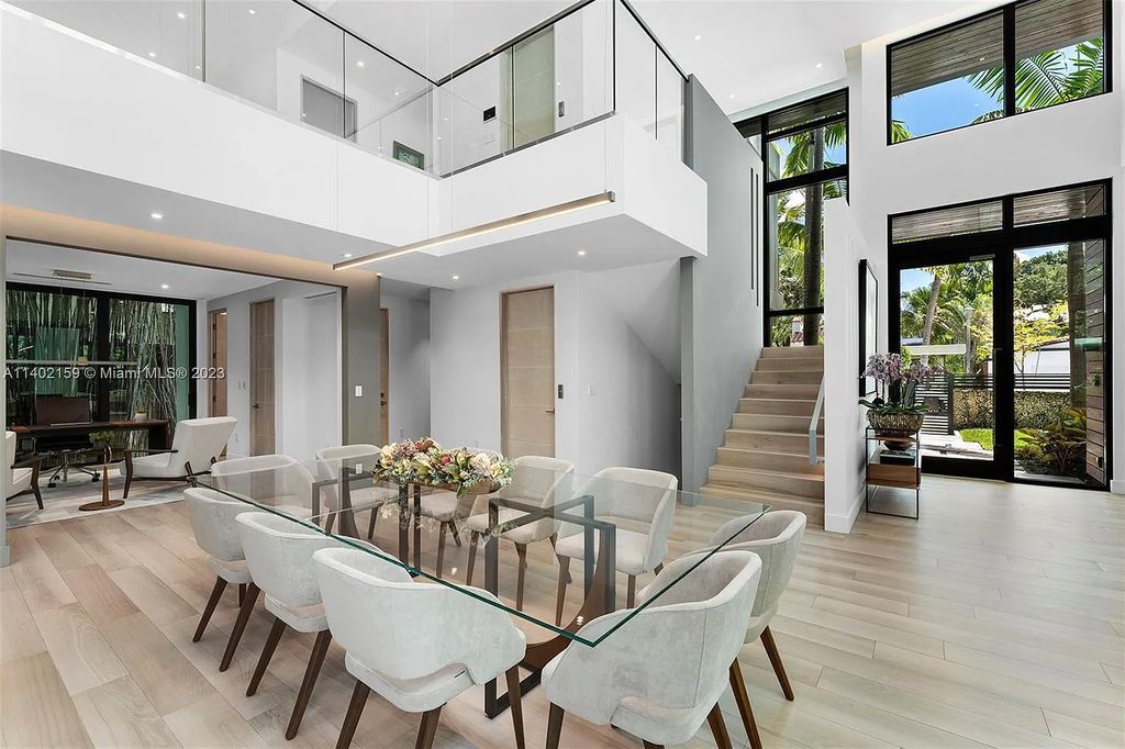 Discover the ultimate Coconut Grove lifestyle at 3230 Crystal Court, a remarkable modern estate in Miami, Florida. This luxurious 7-bed, 9-bath home, designed by architect Charles Treister, seamlessly merges indoor and outdoor spaces for a serene tropical experience. With exquisite finishes, a rare basement with A/C, guest suite apartment, and smart home features, this property offers the perfect blend of elegance and convenience. Enjoy the outdoor oasis with a pool, covered terrace, summer kitchen, and more. Complete with a full house generator, 2-car garage, and prestigious schools nearby, this is Coconut Grove living at its finest.