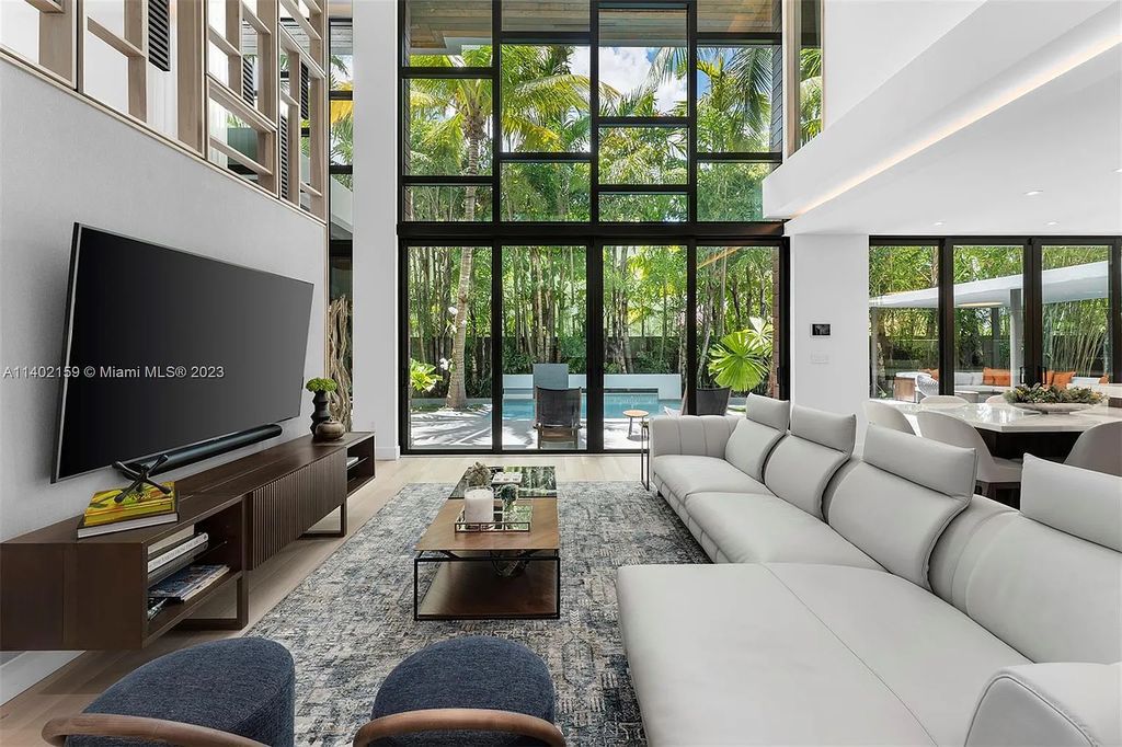 Discover the ultimate Coconut Grove lifestyle at 3230 Crystal Court, a remarkable modern estate in Miami, Florida. This luxurious 7-bed, 9-bath home, designed by architect Charles Treister, seamlessly merges indoor and outdoor spaces for a serene tropical experience. With exquisite finishes, a rare basement with A/C, guest suite apartment, and smart home features, this property offers the perfect blend of elegance and convenience. Enjoy the outdoor oasis with a pool, covered terrace, summer kitchen, and more. Complete with a full house generator, 2-car garage, and prestigious schools nearby, this is Coconut Grove living at its finest.
