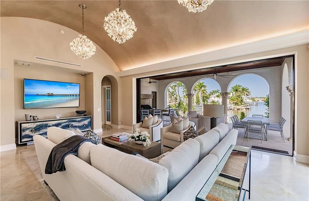 Discover the ultimate Naples, Florida retreat at 2450 Tarpon Road, "The Gateway to Naples Bay." This exceptional property offers a luxurious 4+den/4.5 bath home with 4,450 square feet of living space, recently re-decorated and furnished by Clive Daniel