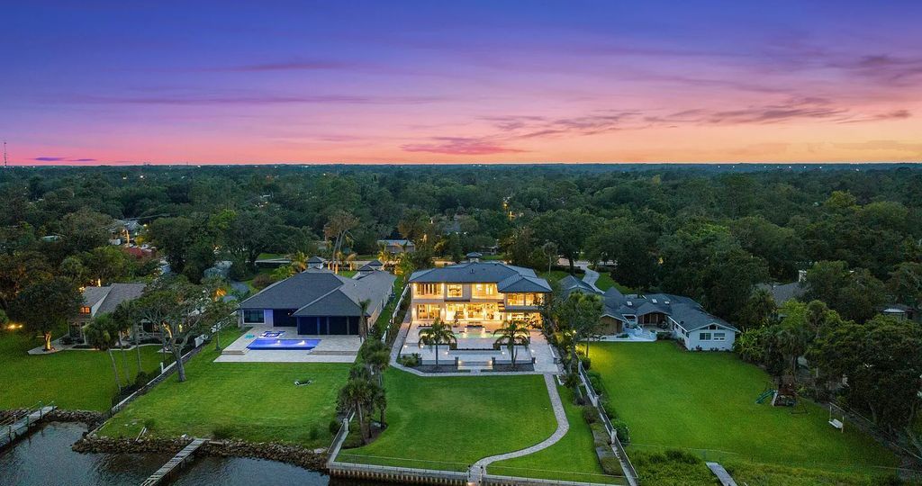 Welcome to 437 N Beach Street, Ormond Beach, Florida—a remarkable riverfront estate designed by renowned architect Ben Butera and built by Forever Homes. This luxurious property offers 5 bedrooms, 5 full bathrooms, and 2 half bathrooms, spanning over 7,500 square feet of living space on a 0.92-acre lot
