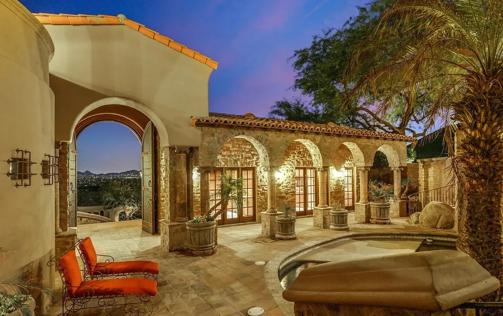 12913 North 119th Street Home in Scottsdale, Arizona. Experience the ultimate in opulent living at the "Castle of Ancala," a sprawling hillside estate spanning over 11,000 sq ft with breathtaking city lights and mountain views. This magnificent property offers luxurious features including a private movie theater, billiard room, fitness center, wine cellar, and a 7-car garage. 
