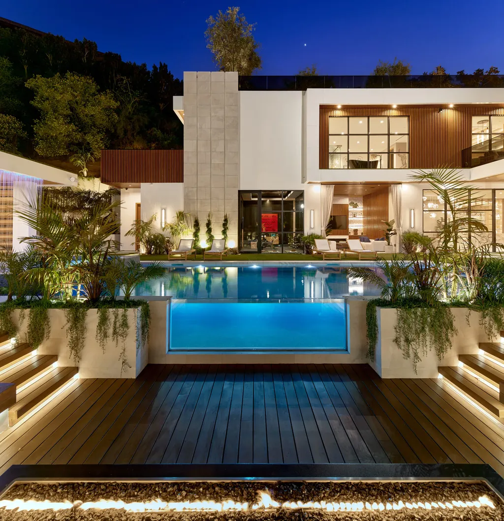 13187 Chalon Road Home in Los Angeles, California. Embrace the epitome of modern luxury living at Allure, a stunning estate designed by award-winning Developer Ramtin Ray Nosrati. Set on 1.3 acres of picturesque California landscape, this idyllic paradise offers resort-quality amenities including a pickleball court, a professional-size basketball/sports court, putting green, and more. 