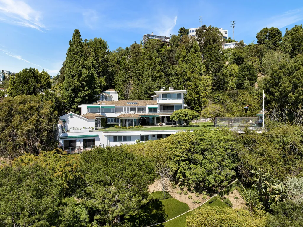 1444 Forest Knoll Drive Home in Los Angeles, California. Welcome to the extraordinary Forest Knoll Estate, a unique opportunity to own one of Los Angeles' most exceptional view estates. Spanning almost 1.4 acres of flat land in lower Sunset Plaza, this property showcases stunning views from downtown to the ocean. The 10,000 square foot main house boasts 7 bedrooms and 11 bathrooms, along with auxiliary structures like a pool house, guest house, and movie pavilion.