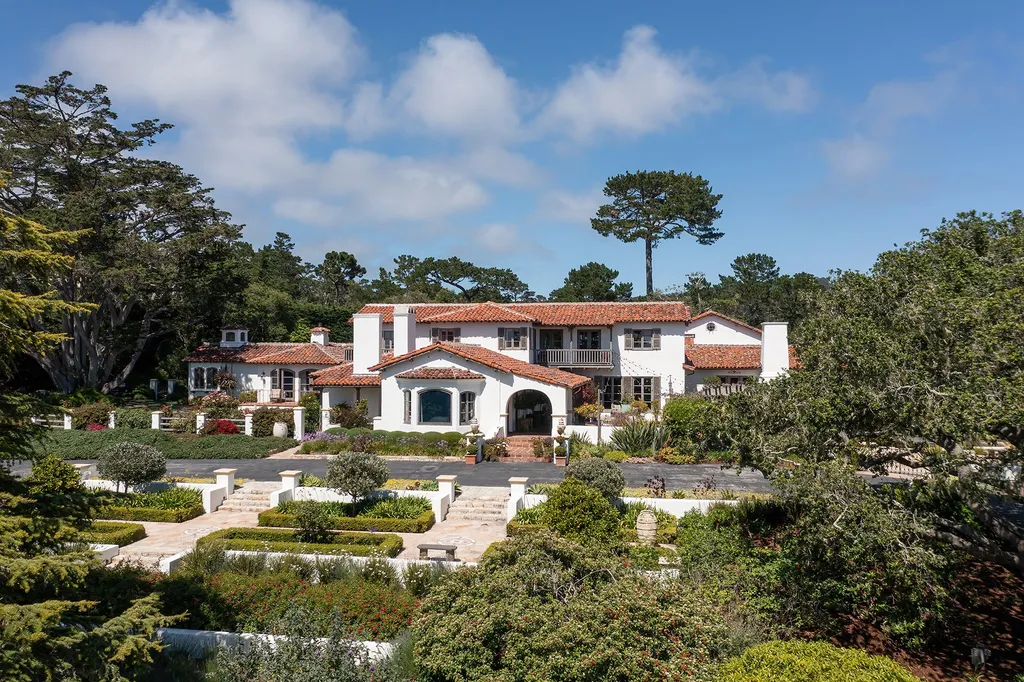 1463 Oleada Road Home in Pebble Beach, California. Explore the timeless elegance of Bella Vista, an original Pebble Beach estate nestled atop Strawberry Hill. This gated 2.6-acre haven offers panoramic views, lush gardens, and modern amenities. With a renovated 8,500+ sq ft main house, a guest house, and a studio carriage house, this Spanish-style compound showcases extraordinary entertaining spaces, outdoor fireplaces, a sport court, and more. Indulge in gourmet living with a chef's kitchen, wine cellar, and billiards room. 