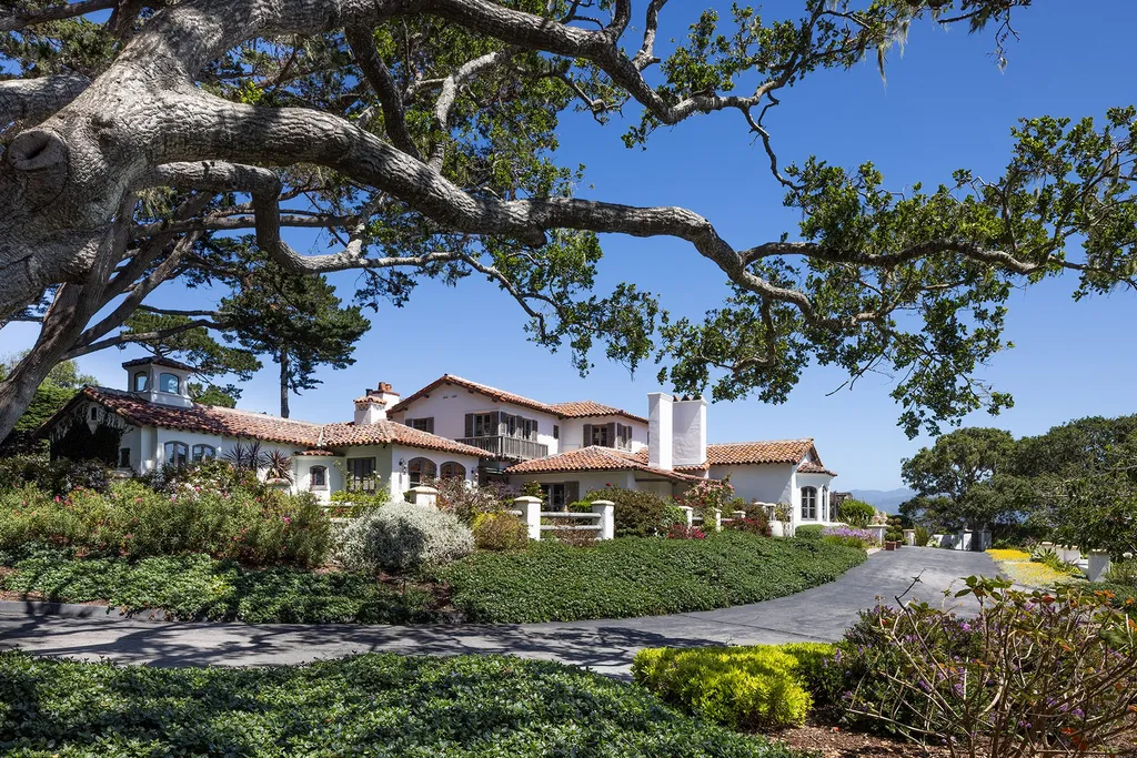 1463 Oleada Road Home in Pebble Beach, California. Explore the timeless elegance of Bella Vista, an original Pebble Beach estate nestled atop Strawberry Hill. This gated 2.6-acre haven offers panoramic views, lush gardens, and modern amenities. With a renovated 8,500+ sq ft main house, a guest house, and a studio carriage house, this Spanish-style compound showcases extraordinary entertaining spaces, outdoor fireplaces, a sport court, and more. Indulge in gourmet living with a chef's kitchen, wine cellar, and billiards room. 