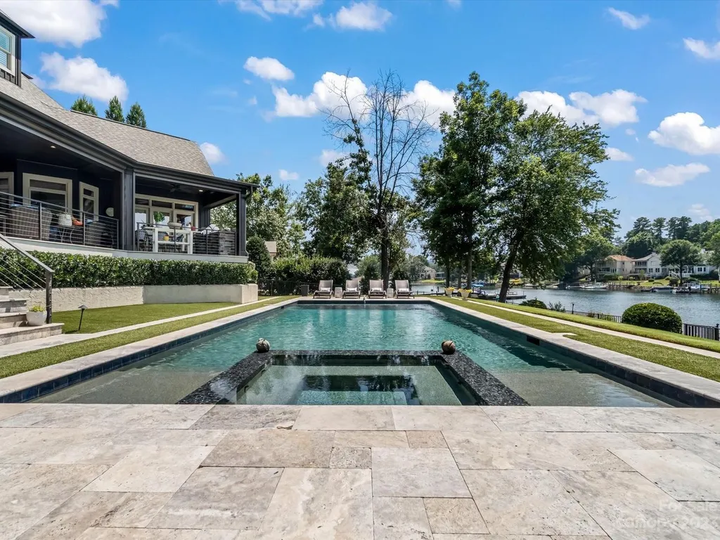 18417 Peninsula Cove Lane Home in Cornelius, North Carolina. Immerse yourself in luxury with this meticulously renovated estate-style home, graced with stunning views of Lake Norman and Peninsula Golf Course from nearly every corner. 