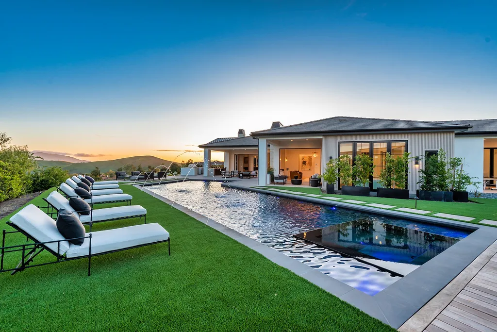 1856 Dawn Meadow Street Home in Thousand Oaks, California. Discover the pinnacle of luxury living in this newly constructed contemporary masterpiece nestled in North Ranch's High Country section. With 11,000 square feet of single-story opulence, this 6-bedroom, 9-bathroom home features a theater, wine wall, game room, and more. 