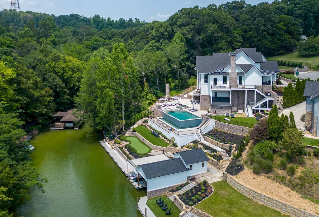 2050 Hidden Cove Lane Home in Knoxville, Tennessee. Welcome to your lakefront dream nestled in the coveted Choto area of West Knoxville! Tucked away at the end of a private road, this exceptional residence graces a tranquil cove, offering both seclusion and awe-inspiring water views. Recently constructed in 2021, this opulent estate seamlessly marries timeless elegance with contemporary refinement.