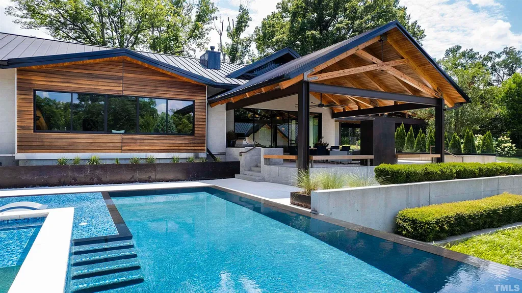 2315 Beechridge Road Home in Raleigh, North Carolina. Step into a modernist masterpiece where open living, natural light, and dramatic vaulted ceilings converge. This architectural gem is a true work of art, featuring a harmonious blend of unique natural woods, contemporary materials, and expansive windows. Discover a sanctuary of tranquility and design, nestled on an acre plus lot in Raleigh's sought-after legacy neighborhood.