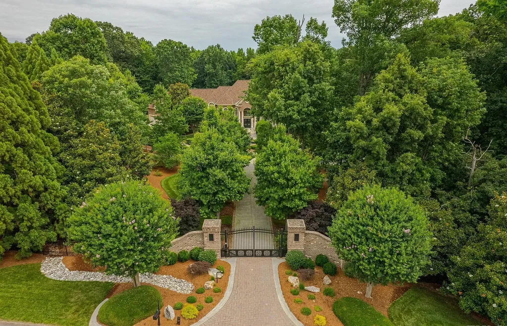 2421 Acanthus Drive Home in Wake Forest, North Carolina. Step into the world of luxury with this exceptional gated estate located in the Back Nine, featured in the Parade of Homes. Spanning 14,438 sqft, this masterfully crafted home boasts 6 bedrooms, 9 bathrooms, and lavish finishes throughout. Enjoy the grand foyer, two kitchens, theater room, wine cellar, and exercise room.