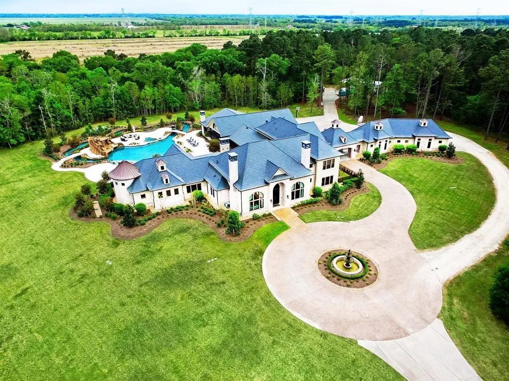 3720 Krenek Road Home in Crosby, Texas. Discover the ultimate luxury living with this stunning custom estate spanning 49 acres, less than 30 minutes from Downtown Houston. With a main house of 9,339 sqft, an entertaining wing of 2,462 sqft, and a guest quarters above a 5-vehicle garage, this property boasts 8 bedrooms, 8 full baths, and 6 half baths.