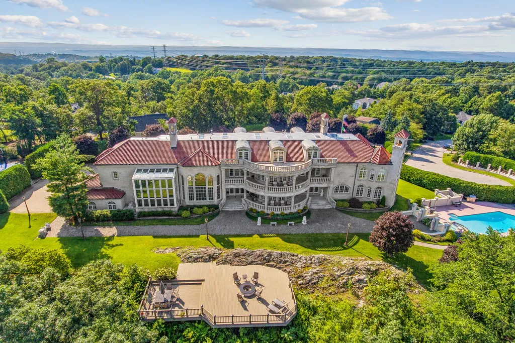 50 Laura Drive Home in Cedar Grove Township, New Jersey. Step into a European masterpiece - a true French Chateau of unparalleled beauty, spanning 14,000 sq ft across 3.8 acres of meticulously landscaped property. Situated at the end of a cul de sac, this architectural gem offers privacy and breathtaking panoramic views of the iconic New York City skyline.