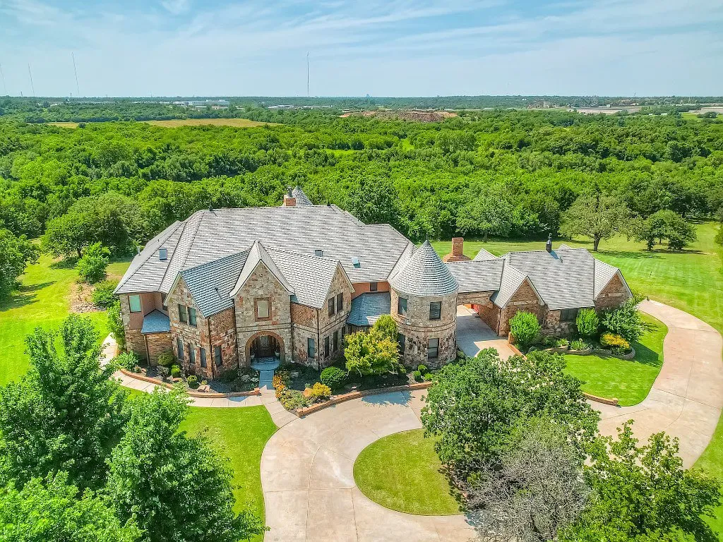 5001 Carrington Place Home in Oklahoma City, Oklahoma. Prepare to be entranced by the awe-inspiring surroundings of this exceptional estate, a harmonious blend of functionality, design, and unparalleled craftsmanship. From the moment you step inside, you'll be greeted by the elegance of quarter-sawn white oak doors, floors, and trim that evoke a sense of refined luxury.