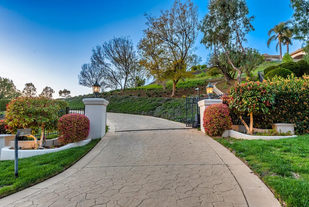 5063 Hunter Valley Lane Home in Westlake Village, California. Discover the epitome of luxury living in this epic Mediterranean compound, nestled on approximately 3.6 acres of prime land behind private gates in guard-gated North Ranch Country Club Estates. Enjoy complete privacy and breathtaking panoramic views from this approximately 9500 square foot hilltop estate.