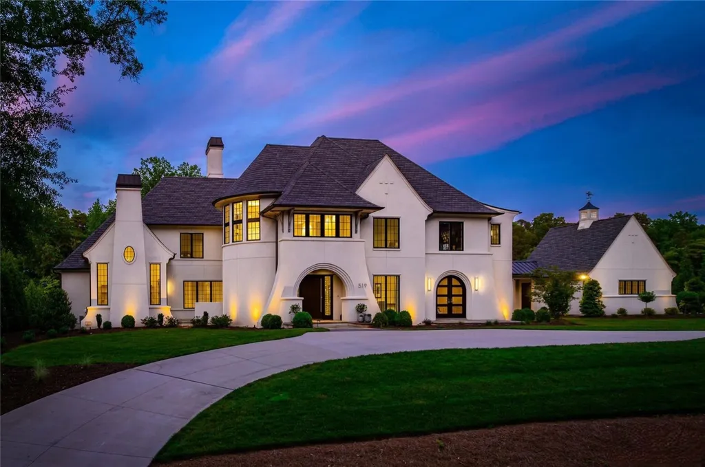 519 Brackenbury Lane Home in Charlotte, North Carolina. Discover a truly unique modern Kingswood Home built in 2019, an exquisite and meticulously designed residence that showcases the epitome of luxury living. With 7,491 square feet spread over 2 acres, this home boasts a custom curved stairwell by Artisan, a stunning glass refrigerated wine display room, and Walker Zanger light gray stone tile throughout the main and upper levels. 