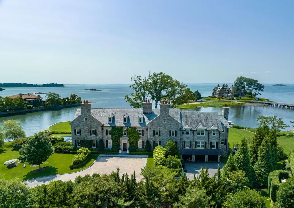 545 Indian Field Road Home in Greenwich, Connecticut. Discover coastal luxury at its finest in this exquisite stone Georgian Colonial nestled within the prestigious Mead Point Association. With panoramic views of Long Island Sound and direct waterfront access, this masterfully designed residence offers over 12,000 square feet of living space on four levels.