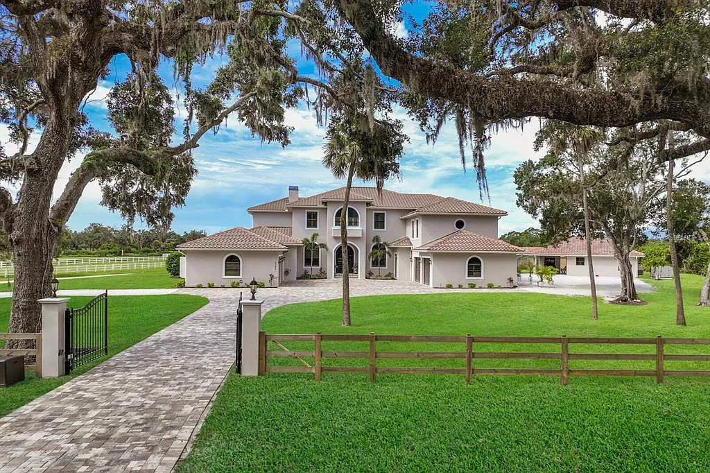 5952 Vanderipe Road Home in Sarasota, Florida. Discover luxurious country living at its finest in this custom-designed home nestled on a sprawling equestrian estate in Myakka Valley Ranches. With over 12 acres of land, two separate lots, and a meticulously crafted residence boasting modern amenities, this property offers a canvas for your dreams to flourish.