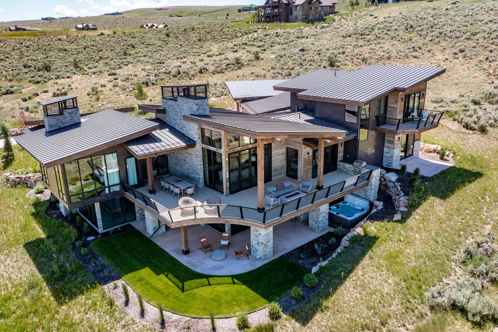 6110 E Blue Wing Loop Home in Kamas, Utah. Immerse yourself in the grandeur of Utah's natural beauty at 6110 E Blue Wing in Victory Ranch. This modern mountain home offers breathtaking 180° views of mountains, Deer Valley ski resort, and rock cliffs from every room.