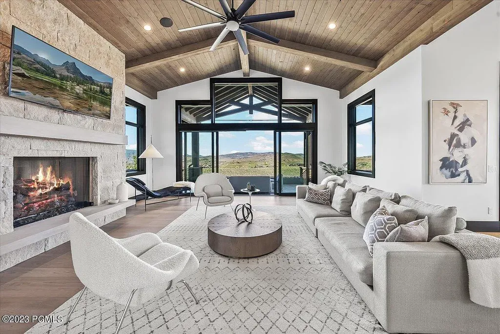 7672 East Moon Dance Circle Home in Heber, Utah. Discover the epitome of modern mountain living within the prestigious gated enclave of Victory Ranch. This unique custom home offers unparalleled views throughout the changing seasons, inviting residents to reconnect with nature and relish in top-tier amenities. Experience the perfect multigenerational mountain retreat, seamlessly blending indoor and outdoor living. With direct access to Victory Ranch's extensive backcountry trails, outdoor adventures are just steps away.