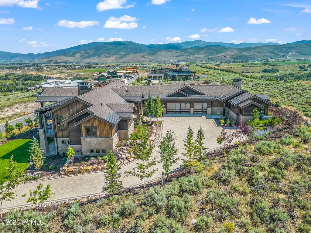 7672 East Moon Dance Circle Home in Heber, Utah. Discover the epitome of modern mountain living within the prestigious gated enclave of Victory Ranch. This unique custom home offers unparalleled views throughout the changing seasons, inviting residents to reconnect with nature and relish in top-tier amenities. Experience the perfect multigenerational mountain retreat, seamlessly blending indoor and outdoor living. With direct access to Victory Ranch's extensive backcountry trails, outdoor adventures are just steps away.