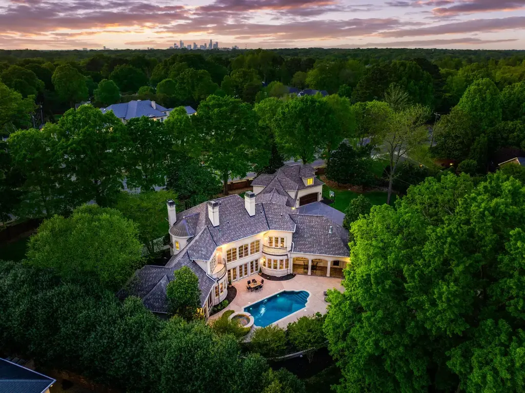 8600 Fairview Road Home in Charlotte, North Carolina. Discover the epitome of luxury living at Fairview Manor Estate in the coveted Carmel Park neighborhood. This gated 1.27-acre property boasts a stunning great room with a 2-story fireplace, exquisite millwork, and floor-to-ceiling windows. 