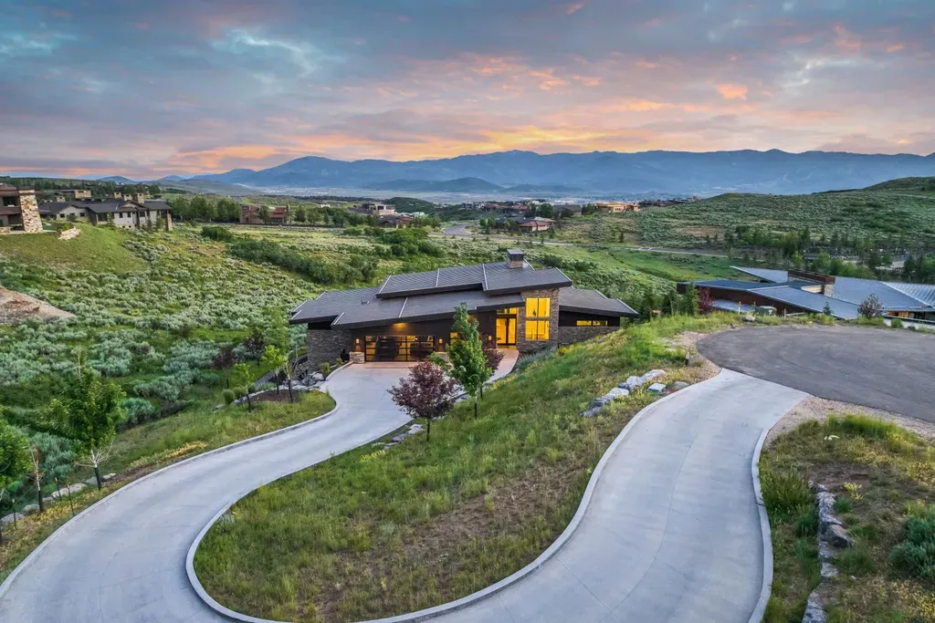 9310 Golden Spike Court Home in Park City, Utah. Discover this extraordinary custom home nestled on a 1.59-acre lot in Promontory's sought-after Summit neighborhood. Boasting stunning stone and cedar architecture under a striking copper roof, this home offers unobstructed ski area views and direct access to acres of open space. 
